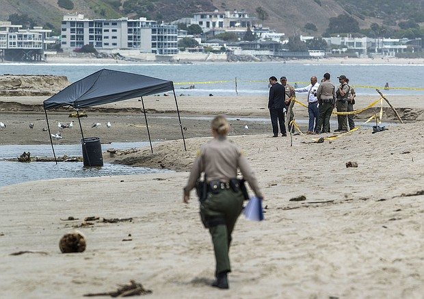 Members of the Los Angeles County Sheriff's Department investigate at  Malibu Lagoon State Beach, where a body was found inside a 55-gallon drum.
Mandatory Credit:	Mel Melcon/Los Angeles Times/Getty Images