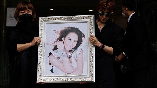 Relatives carry a portrait of singer and songwriter CoCo Lee at a crematorium after the funeral in Hong Kong.
Mandatory Credit:	Tyrone Siu/Reuters