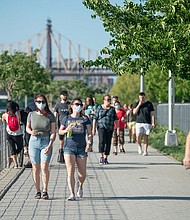 People walk in Gantry Plaza State Park in New York City.
Mandatory Credit:	Alexi Rosenfeld/Getty Images/File