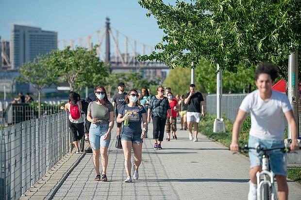 People walk in Gantry Plaza State Park in New York City.
Mandatory Credit:	Alexi Rosenfeld/Getty Images/File