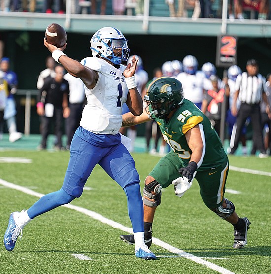 Hampton University’s quarterback Chris Zellous handles the ball during the “Battle of the Bay” against Norfolk State University last September. Hampton defeated NSU 17-7 in the legendary battle.