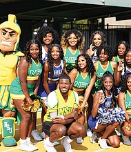 Cheerleaders from both teams pause for a photo during the game.