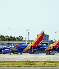A mother is suing Southwest Airlines for racial discrimination, saying she was accused of human trafficking when traveling with her biracial child.
Mandatory Credit:	Ashley Landis/AP