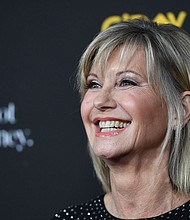 Olivia Newton-John’s husband and daughter say she’s visited them as a "blue orb" since dying. Newton-John is seen here in Los Angeles in January 2018.
Mandatory Credit:	Robyn Beck/AFP/Getty Images