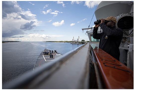 230809-N-QI593-1303 RIGA, Latvia (Aug. 9, 2023) Logistics Specialist 3rd Class Raymond Akintunde, from La Marque, Texas, looks for surface vessels …