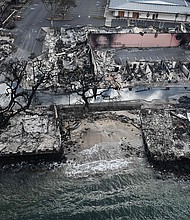 An aerial image taken on August 10, 2023 shows destroyed homes and buildings on the waterfront burned to the ground in Lahaina in the aftermath of wildfires in western Maui, Hawaii.
Mandatory Credit:	Patrick T. Fallon/AFP/Getty Images