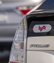 Lyft signage is pictured on a vehicle as it exits the ride-sharing pickup at San Francisco International Airport on February 3, 2022.
Mandatory Credit:	David Paul Morris/Bloomberg/Getty Images