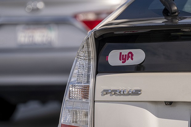 Lyft signage is pictured on a vehicle as it exits the ride-sharing pickup at San Francisco International Airport on February 3, 2022.
Mandatory Credit:	David Paul Morris/Bloomberg/Getty Images