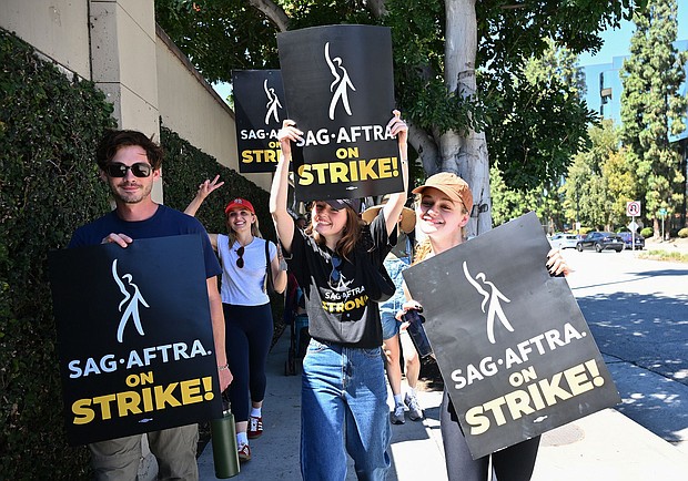 Matt Dallas, Chloe Fineman and Joey King join SAG-AFTRA and WGA Members and Supporters as they walk the picket line in support of the SAG-AFTRA and WGA strike on Day 2 at the Warner Bros. Studio on July 14, in Burbank, California.
Mandatory Credit:	Michael Buckner/Variety/Getty Images
