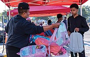 Wayman Hollis and his sons, Wayman Hollis Jr. and Landon Hollis, were in charge of organizing backpacks for the giveaway.