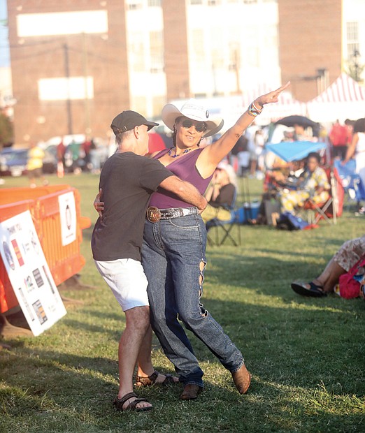 Jarene Fleming and her dance partner Richard Day, below, also of Richmond, felt the rhythm of Louisiana-based group, Dikki Du & the Zydeco Krewe. The group had one of the many performances that got the crowd moving during the event.