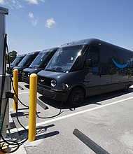 Electric Amazon delivery vans charge their batteries at an Amazon facility in Chicago, 2022.
Mandatory Credit:	Mustafa Hussain/Getty Images