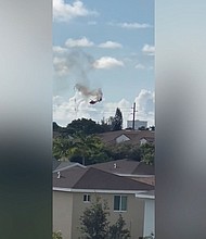 A helicopter goes down in Pompano Beach, Florida, on Monday, August 28.
Mandatory Credit:	Courtesy Buck Daily