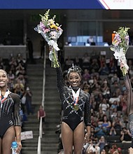 From left, Shilese Jones, Simone Biles and Leanne Wong pose for a photograph after placing second, first and third place, respectively, in all-around competition at the championships.