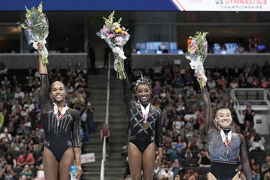 From left, Shilese Jones, Simone Biles and Leanne Wong pose for a photograph after placing second, first and third place, respectively, in all-around competition at the championships.