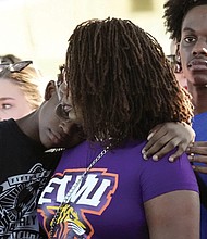 Residents gather at a prayer vigil Sunday for the victims of a mass shooting a day earlier in Jacksonville, Fla.