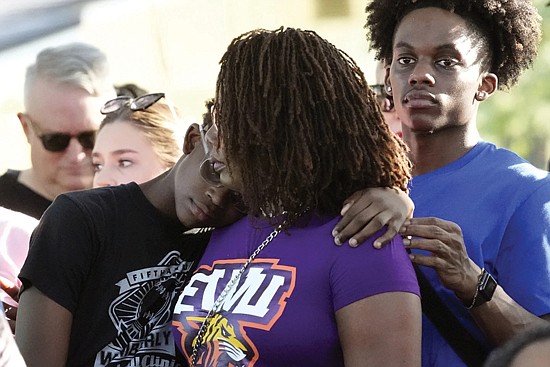 Residents gather at a prayer vigil Sunday for the victims of a mass shooting a day earlier in Jacksonville, Fla.