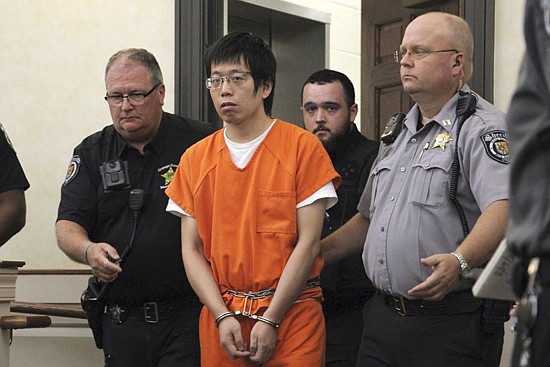 Tailei Qi, the graduate student suspected in the fatal shooting of a University of North Carolina at Chapel Hill faculty member, center, makes his first appearance at the Orange County Courthouse in Hillsborough, N.C., on Tuesday.