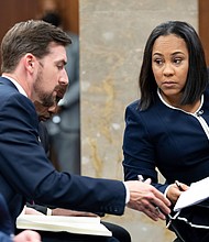 Willis speaks with her team on May 2, 2022,  during proceedings in Atlanta to seat a special purpose grand jury to look into the 2020 election subversion case.
Mandatory Credit: