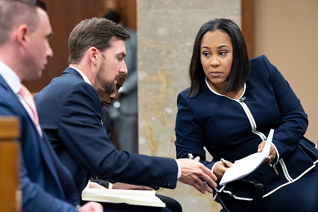 Willis speaks with her team on May 2, 2022,  during proceedings in Atlanta to seat a special purpose grand jury to look into the 2020 election subversion case.
Mandatory Credit: