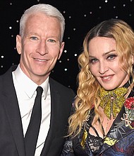 Anderson Cooper and Madonna pose together at the Billboard Women in Music 2016 event on December 9, 2016 in New York City. Cooper has mixed feelings about the time he briefly shared a stage with Madonna.
Mandatory Credit:	Kevin Mazur/Getty Images