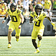 Bucky Irving (0) heads to the end zone trailed by quarterback Bo Nix (10) (AP Photo)