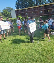 Patrick Saddon and others at Monday rally against conditions at Red Oak apartments. The rally, attended by several residents, took place on a vacant lot in 3600 block of Chamberlayne Avenue.