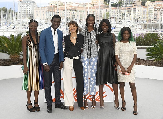 Actors Aminata Kane, from left, Amadou Mbow, director Mati Diop, actors Mame Sane, Nicole Sougou and Mariama Gassama pose for photographers at the photo call in Cannes in May 2019 for the film “Atlantique.”