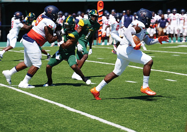 Virginia State University running back Upton “Juice” Bailey rushes for yards during the game against Norfolk State University last Saturday.