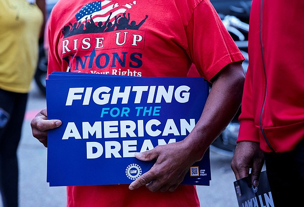 A United Auto Workers union member holds a sign outside Stellantis Sterling Heights Assembly Plant, to mark the beginning of contract negotiations in Sterling Heights, Michigan on July 12.
Mandatory Credit:	Rebecca Cook/Reuters