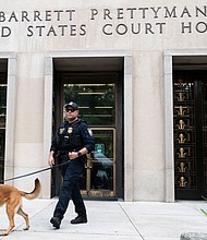 A Homeland Security canine unit sweeps one of the entrances to the E. Barrett Prettyman United States Courthouse in Washington, DC, on August 3.
Mandatory Credit:	Roberto Schmidt/Getty Images