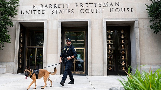 A Homeland Security canine unit sweeps one of the entrances to the E. Barrett Prettyman United States Courthouse in Washington, DC, on August 3.
Mandatory Credit:	Roberto Schmidt/Getty Images