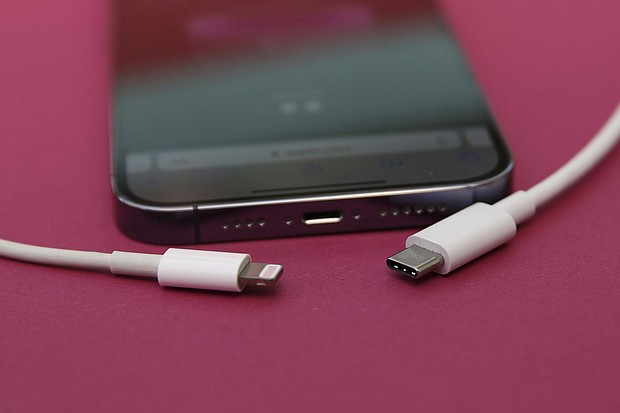 An iPhone 14 Pro with a Lightning cable (left) and a USB-C cable (right).
Mandatory Credit:	Christoph Dernbach/picture-alliance/dpa/AP