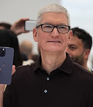 Apple CEO Tim Cook holds the new iPhone 14 at an Apple event at their headquarters in Cupertino, California, U.S. September 7, 2022. Apple is expected to debut its iPhone 15 lineup on September 12 at the company’s annual September keynote event.
Mandatory Credit:	Carlos Barria/Reuters