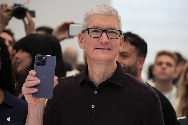 Apple CEO Tim Cook holds the new iPhone 14 at an Apple event at their headquarters in Cupertino, California, U.S. September 7, 2022. Apple is expected to debut its iPhone 15 lineup on September 12 at the company’s annual September keynote event.
Mandatory Credit:	Carlos Barria/Reuters
