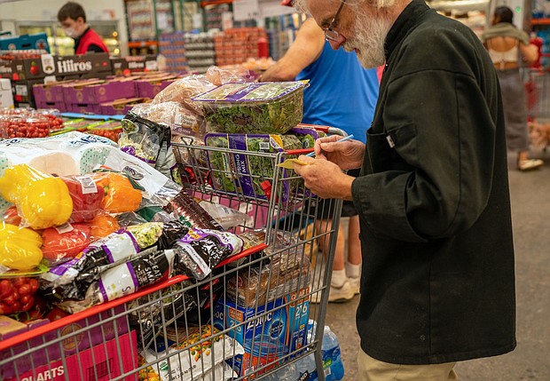 A person goes through a note pad while shopping for items at a Costco Wholesale store on September 6 in Colchester, Vermont.
Mandatory Credit:	Robert Nickelsberg/Getty Images