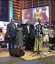 Tyre Nichols’ stepfather Rodney Wells, second from left, and Mr. Nichols’ mother, RowVaughn Wells, third from left, close their eyes in prayer before a news conference about federal charges filed against five former officers in Mr. Nichols’ death on Tuesday in Memphis, Tenn.