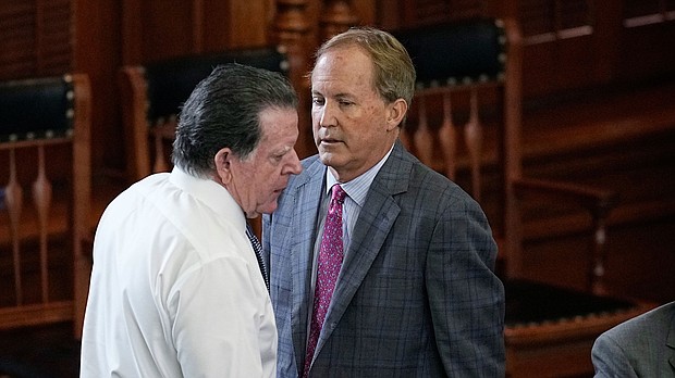 Suspended Texas state Attorney General Ken Paxton, right, talks with his attorney, Dan Cogdell during his impeachment trial in the Senate chamber at the Texas State Capitol in Austin on September 15.
Mandatory Credit:	Eric Gay/AP