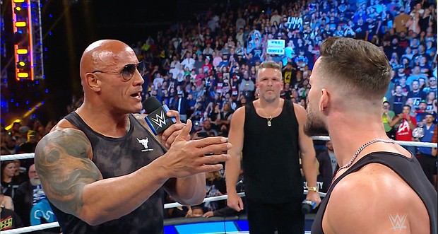 Caption:	Dwayne Johnson makes a WWE appearance on September 15.
Mandatory Credit:	From WWE