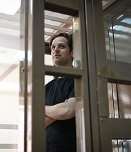 Evan Gershkovich stands inside a defendants' cage before a hearing in Moscow on June 22.
Mandatory Credit:	Natalia Kolesnikova/AFP/Getty Images/File
