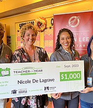 Nicole De Lagrave takes picture with the teacher of the year award presented with the Oregon Lottery partners.