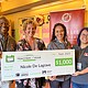 Nicole De Lagrave takes picture with the teacher of the year award presented with the Oregon Lottery partners.