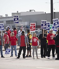 United Auto Workers members strike at the Ford Michigan Assembly Plant on Saturday, Sept. 16, 2023, in Wayne, Michigan. This is the first time in history that the UAW is striking all three of the Big Three auto makers, Ford, General Motors, and Stellantis, at the same time. (Bill Pugliano/Getty Images/TNS)
