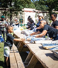 Jacoby Grandison was among Richmond area youngsters who attended Upon This Rock World Ministries’ Community Day Saturday at Pine Camp Cultural and Arts Center. Volunteer Sherrelle Johnson serves food made by Holy Smoke. Other activities included inspiring ministries and baptismal ceremonies.