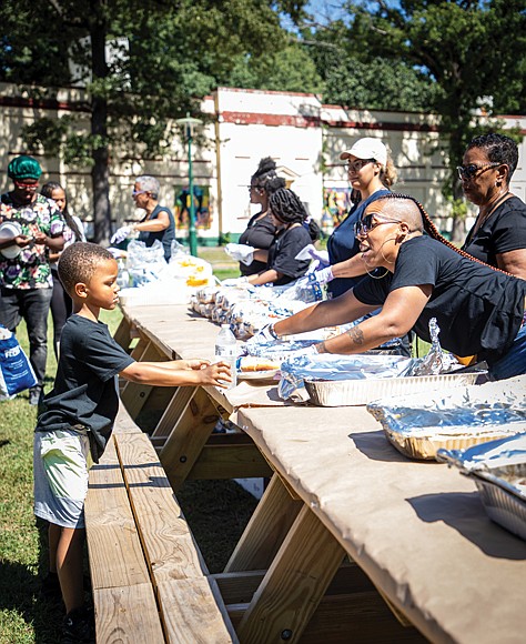 Jacoby Grandison was among Richmond area youngsters who attended Upon This Rock World Ministries’ Community Day Saturday at Pine Camp Cultural and Arts Center. Volunteer Sherrelle Johnson serves food made by Holy Smoke. Other activities included inspiring ministries and baptismal ceremonies.