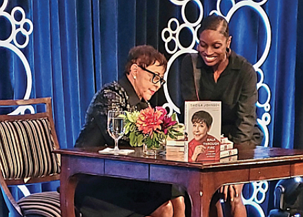 Sheila Johnson, CEO of Salamander Hotels & Resorts, signs a copy of her new book, “Walk Through Fire,” for Hillari Hawkins of Alexandria.