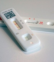 Covid-19 antigen home tests indicating a positive result are photographed in New York, April 5. The Biden administration has announced that it is providing $600 million in funding to produce new at-home Covid-19 tests and is restarting a website allowing Americans to again order up to four free tests per household.
Mandatory Credit:	Patrick Sison/AP