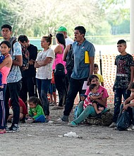 Migrants who crossed into the U.S. from Mexico wait to be processed by U.S. Border Patrol agents in Eagle Pass, Texas.
Mandatory Credit:	Eric Gay/AP