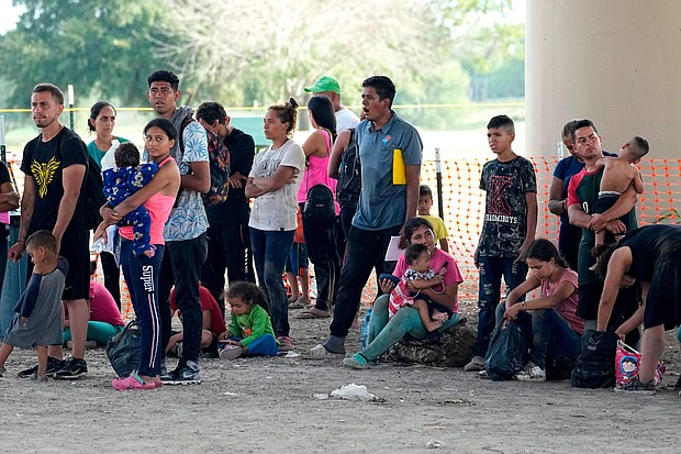 Migrants who crossed into the U.S. from Mexico wait to be processed by U.S. Border Patrol agents in Eagle Pass, Texas.
Mandatory Credit:	Eric Gay/AP