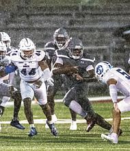 Virginia Union running back Curtis Allen runs the ball in the rainstorm Saturday against challengers from Fayetteville State.